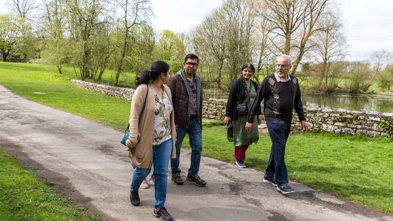 Family exploring the gardens in spring at Sizergh Castle, Cumbria